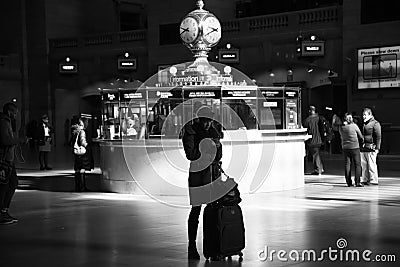 Traveler woman checking her cellphone at Grand Central Station. Editorial Stock Photo